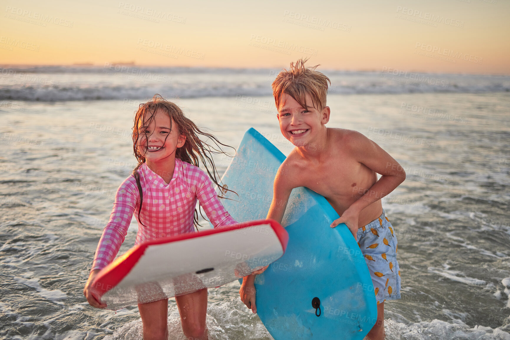 Buy stock photo Happy children, beach and learning to surf for fun and bonding on bali summer vacation. Kids, boy and girl siblings on tropical holiday while surfing with board for water sports, splash and swim