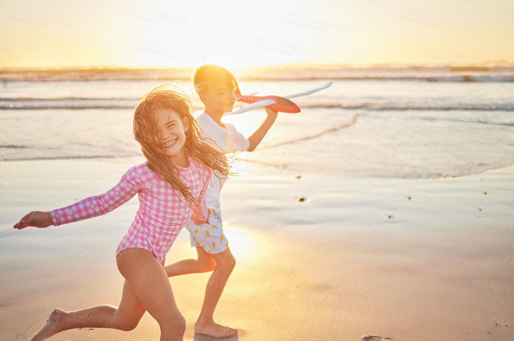 Buy stock photo Beach, vacation and children running with airplane toy for fun activity while on tropical summer vacation by the sea at sunset. Sibling boy and girl or sister and brother enjoying a trip in maldives