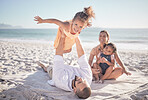 Family, children and love with a girl on a beach holiday with her parents and sister during summer. Kids, travel and ocean with a female child or daughter on the sand by the sea with her father