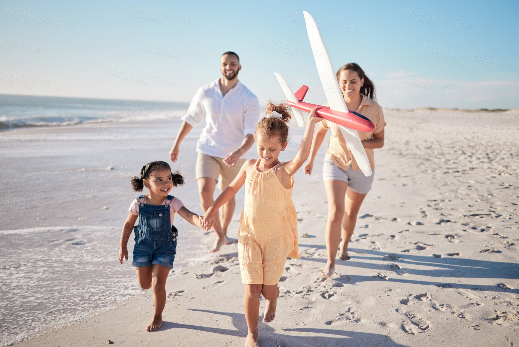 Buy stock photo Hawaii, happy family and beach with happy children running, toy airplane and freedom together. Travel, wellness and energy with excited kids run and have fun, laugh on fun activity with mom and dad
