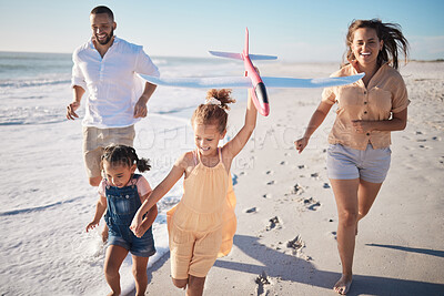 Buy stock photo Energy, family and beach run by happy kids and parents having fun with airplane and active race along ocean. Love, freedom and happy family with children playing and bonding, excited with mom and dad
