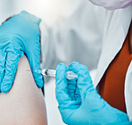 Medicine, healthcare and doctor doing a covid vaccine on a patient at hospital during pandemic. Closeup hands of a medical professional with gloves doing an antibody injection with syringe at clinic.