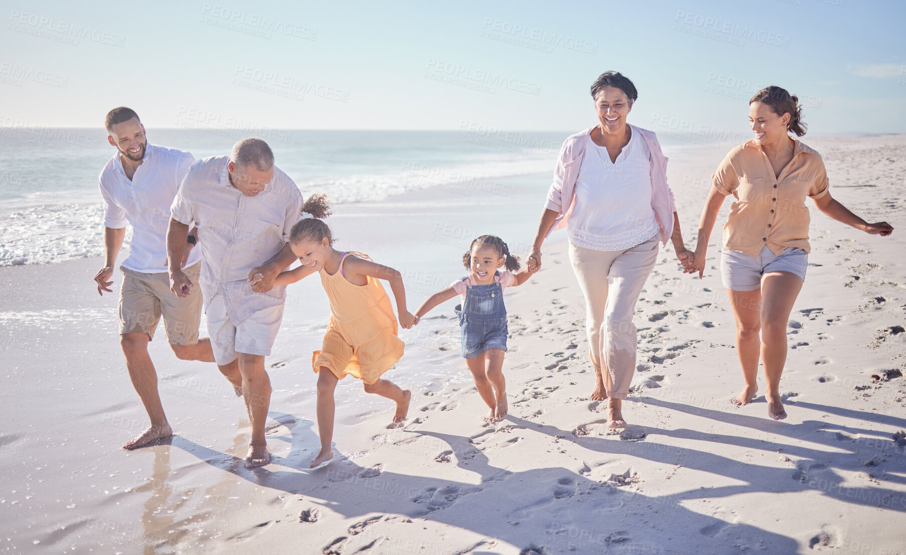 Buy stock photo Beach walk, family summer and children holding hands with grandparents while walking by the sea on holiday. Parents, girl kids and senior people walking by the ocean on travel vacation in Brazil