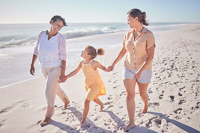Buy stock photo Family smile at beach, mom and grandmother hold hands with girl child on holiday. Children love vacation by the sea, happy grandma in retirement and walking in sand together as they relax as a group 