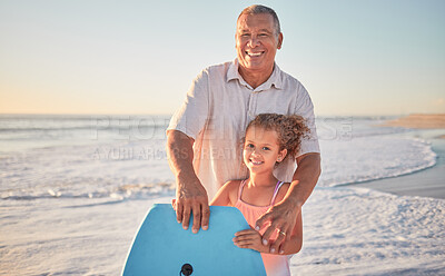 Buy stock photo Beach, grandfather and girl learning to surf from a happy senior man in her family on a summer holiday outdoors. Smile, sports and old man teaching or training a child surfing on a board in the ocean