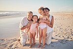 Grandparents with children, happy on beach on holiday and enjoying retirement. Grandpa, grandma and kids enjoy  afternoon playing in ocean summer sun.  Family love time together, by the sea and sand
