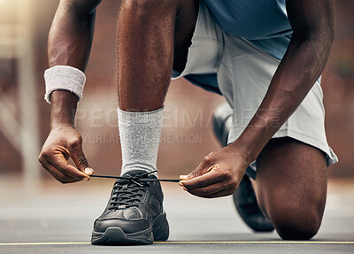 Buy stock photo Fitness, running and shoes of black man for training for sports, motivation and start of workout. Exercise, health and wellness with runner fixing his laces in road for cardio, energy and performance