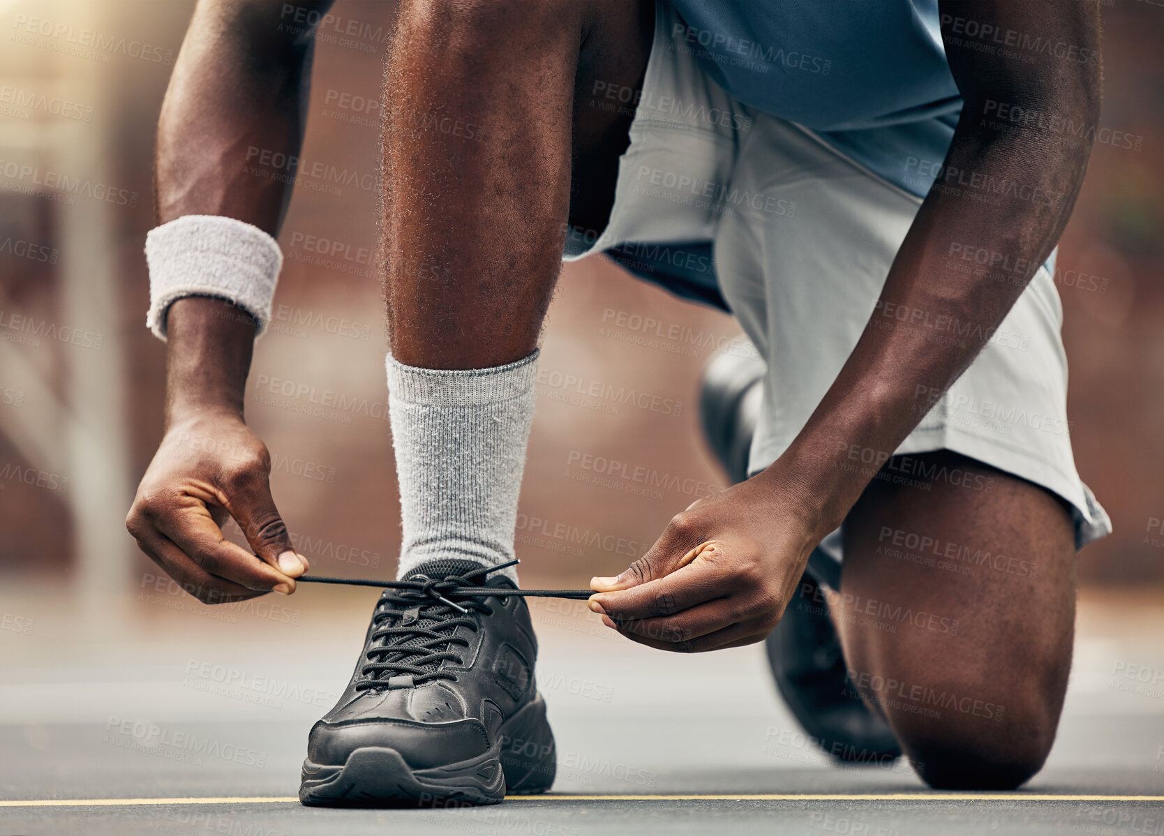 Buy stock photo Fitness, running and shoes of black man for training for sports, motivation and start of workout. Exercise, health and wellness with runner fixing his laces in road for cardio, energy and performance