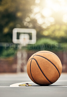 Buy stock photo A ball used for basketball on an outdoor basketball court in a park. Mockup for sport, training and getting ready to play a match for exercise. Summer, sports and playing games outside to keep fit