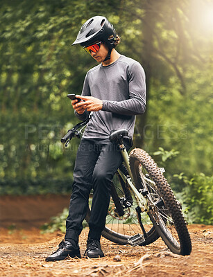 Buy stock photo Fitness, forest and phone with man and bike relax with internet, social media or online in nature. Wellness, mountain and sports with athlete on adventure, exercise or peace training on park trail 