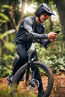 Buy stock photo Fitness, phone and forest cyclist in nature and sustainability New Zealand woods with gps location, health data and tracking app. Smile, happy and training sports biker with helmet and 5g mobile tech