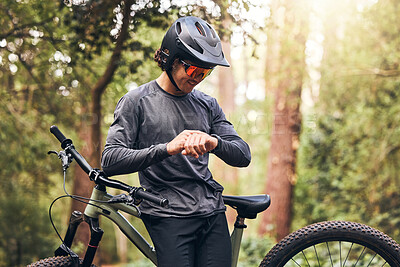 Buy stock photo Time, bicycle and man cycling in nature checking his stopwatch in a cardio workout, training and exercise outdoors. Fitness, forest and healthy person proud of his bike riding in the natural woods 