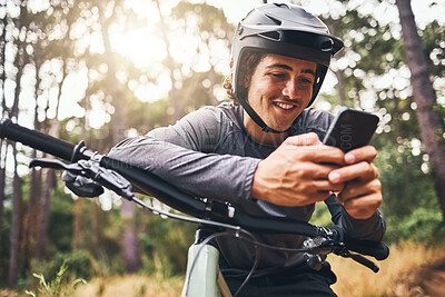 Buy stock photo Fitness, bike and phone with man texting and cycling in a forest, happy and relax in nature with cyclist. Gps, internet and map with sports male enjoying freedom and easy online direction in woods
