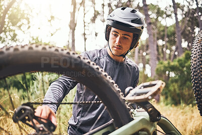 Buy stock photo Mountain bike, fitness or cyclist fixing chain in exercise, training or workout in Norway forest or nature woods. Thinking man, bicycle or sports athlete and helmet or motivation in equipment repair 