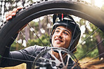 Bicycle, cycling and man check tire quality, pressure or stability for nature travel, exercise or fitness training. Mountain bike sports person checking wheel for health workout in Canada forest park