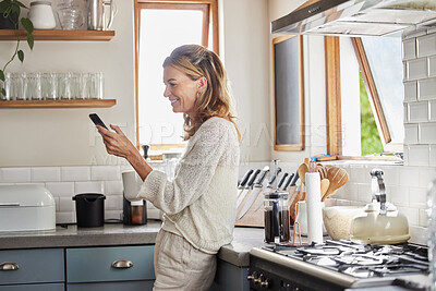 Buy stock photo Mature woman reading phone news, social media notification and mobile apps in Australia kitchen home. Happy lady typing smartphone, online social network and 5g web technology connection in apartment