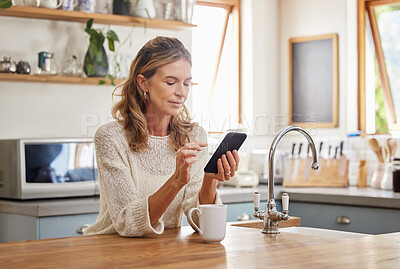 Buy stock photo Senior woman reading phone news, mobile apps and social media notification in morning home kitchen. Relax retirement lady typing smartphone, online network website and 5g tech connection in apartment