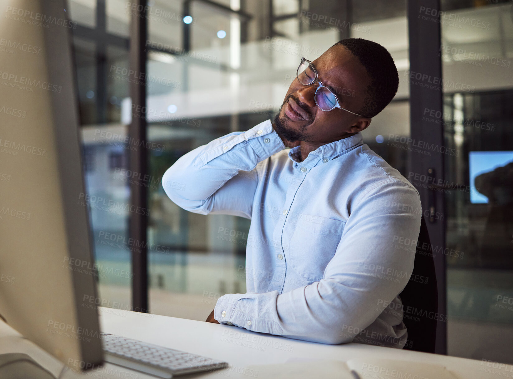 Buy stock photo Burnout, stress and neck pain by businessman working on a computer late in office, injury and discomfort. Corporate employee suffering from hurt and tender spinal injury while working overtime 