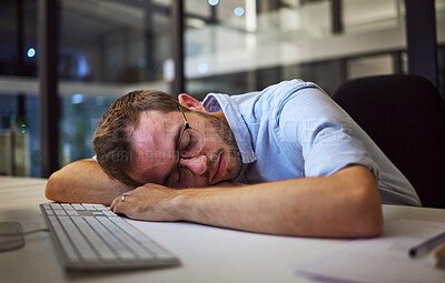 Buy stock photo Night sleep, business burnout and businessman sleeping at his desk in his dark office at work. Tired corporate employee, worker or manager with stress taking a nap at a table while working overtime 