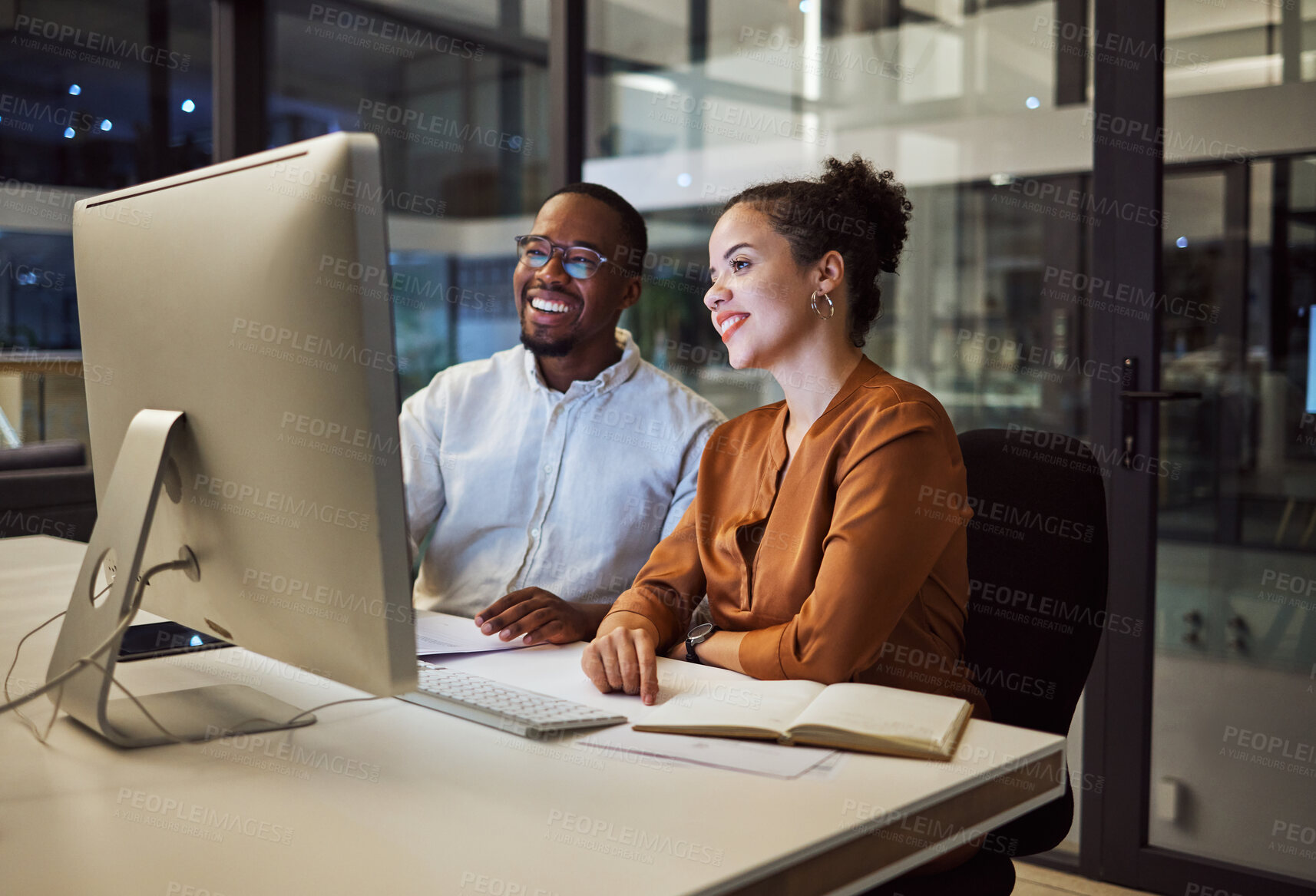 Buy stock photo Night meeting, internet business and employees talking about web design on a computer in a dark office at night. African workers happy on company website and working overtime for partnership