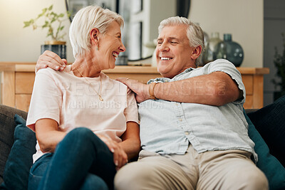 Buy stock photo Senior couple, happy and relaxing on a sofa at home laughing at comic joke and bonding as husband give wife shoulder massage to relax. Old man and woman enjoying love in retirement in lounge at home