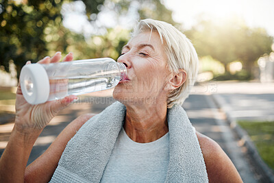 Buy stock photo Senior fitness woman drinking water bottle outdoors after training, running workout and exercise in neighborhood street. Thirsty elderly lady runner hydration rest for cardio wellness or marathon jog