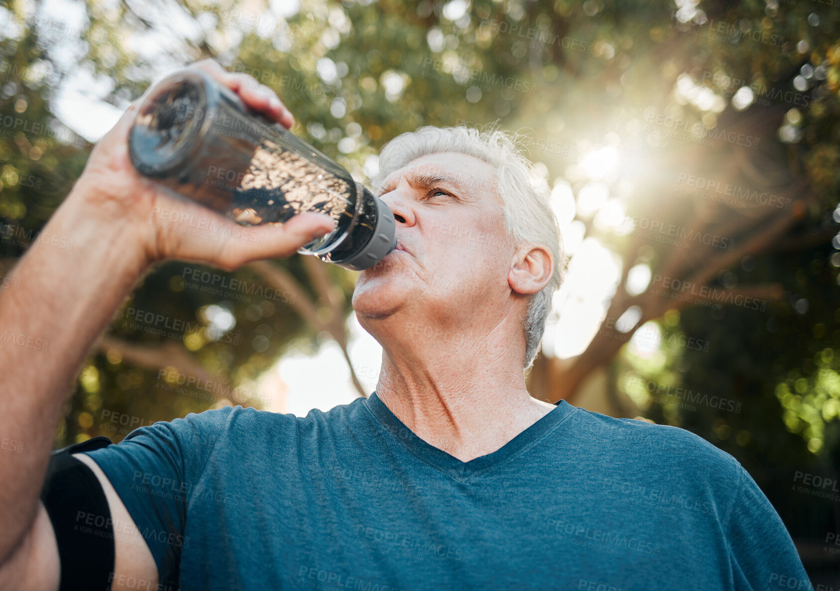 Buy stock photo Water, nature fitness and senior man training for health in a park for body health in summer. Elderly athlete or runner with drink after cardio workout, running or outdoor sports exercise 