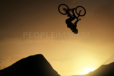 Buy stock photo Cyclist, fitness and stunt jump at sunset in Colorado countryside nature mountains in fitness, exercise or training. Danger risk, extreme sports mountain bike or freedom man in sunrise energy workout