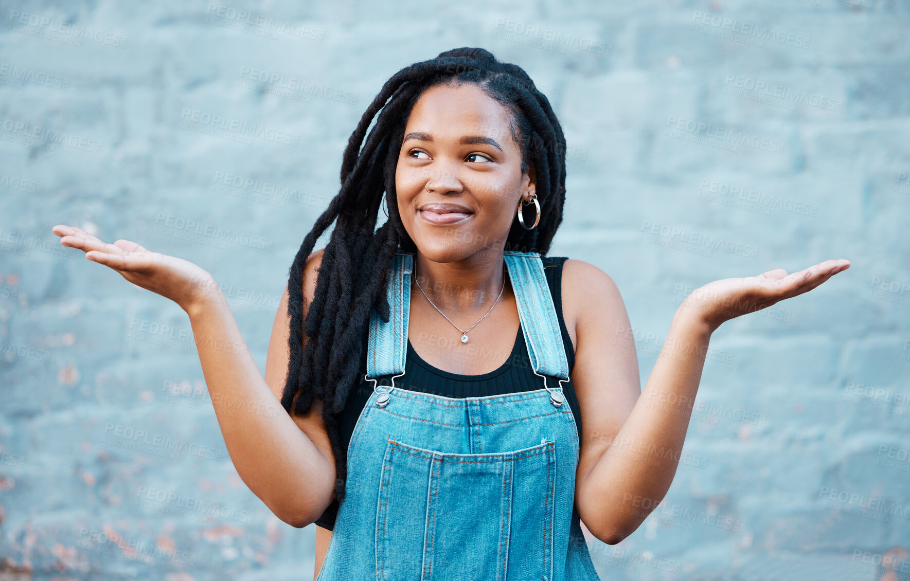 Buy stock photo Model, smile and hands for gesture of confusion pose in street against blue wall. Black woman, question and confused sign in city against urban background with dreadlocks in Cape Town, South Africa