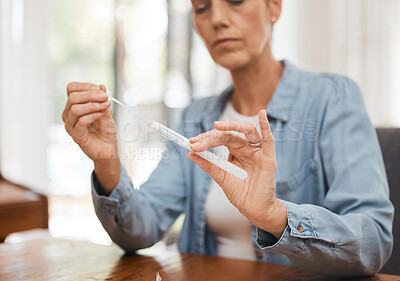 Buy stock photo Woman, hands and covid for PCR, test or results on table for healthcare diagnosis at home by desk. Sick female testing for corona virus, disease or illness holding kit for self screening in pandemic