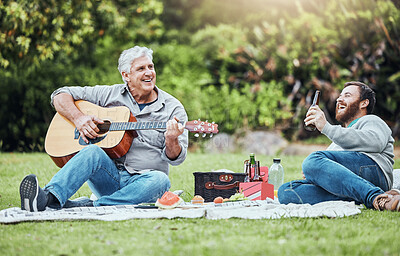 Buy stock photo Guitar, father and son on park picnic with beer and music during holiday in Australia in summer. Senior dad and man laughing at comic sound on instrument while happy on vacation in a nature garden