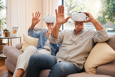 Buy stock photo Gaming, vr and senior couple on a sofa, virtual reality and fun in a living room. Metaverse, fantasy and retirement by elderly man and woman enjoying playful, creative and virtual game in their home 