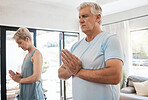 Fitness, yoga and senior couple doing pilates exercise for mind and body wellness in living room. Retirement, namaste and elderly man and woman with zen, calm and health lifestyle doing meditation.