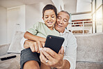 Grandfather, kid and phone on sofa in home playing games or old man learning social media from boy. Love, relax and grandpa with child on 5g mobile, app or smartphone web surfing and bonding together