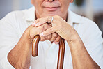 Old man hands, walking stick and disability from osteoporosis, arthritis and aging wrinkles. Closeup of lonely, retirement and disabled senior widower with dementia, pain and wooden cane for support 