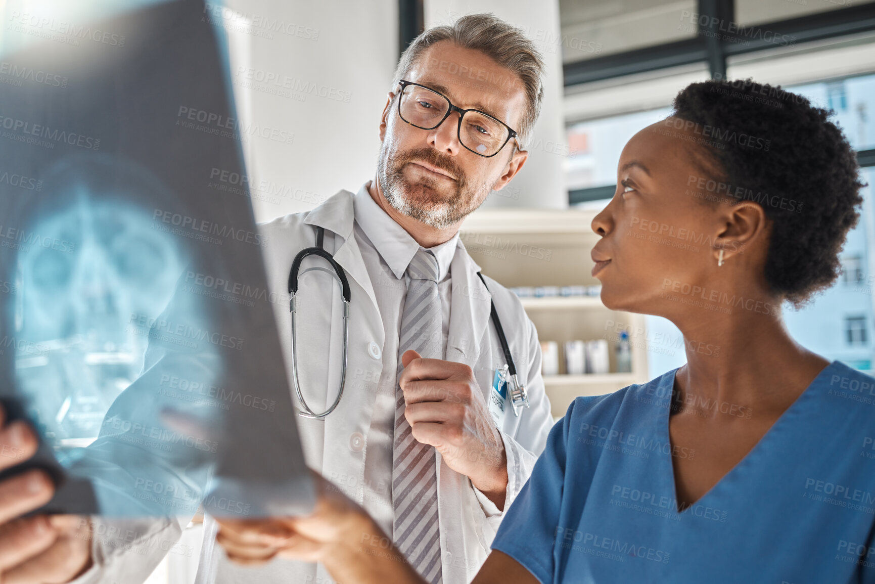 Buy stock photo Brain, x ray and neurology doctors in a meeting working on a skull injury in emergency room in a hospital. Diversity, cancer and healthcare medical neurologist checking mri or xray scan with teamwork