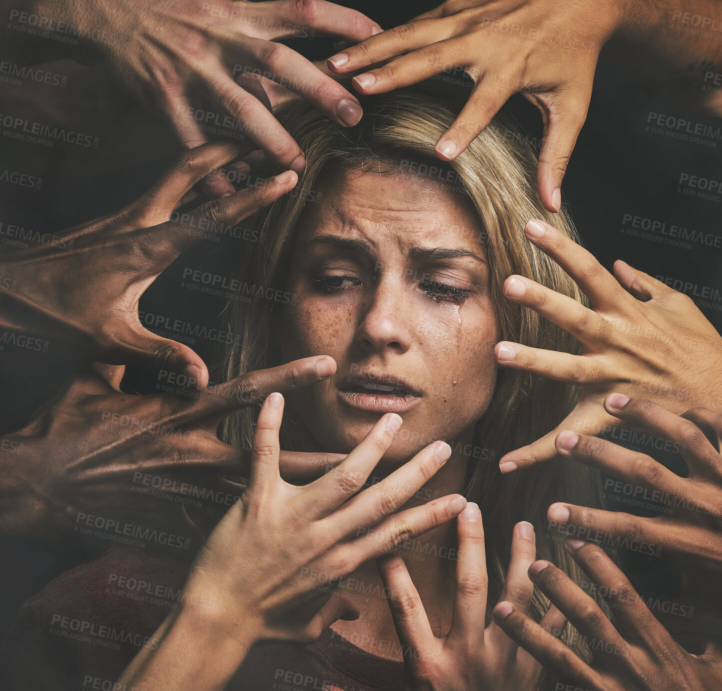 Buy stock photo Many hands, face and abuse with a woman victim feeling fear, alone or crying in studio on a dark background. Sad, pain and violence with a scared female suffering with stress or social anxiety