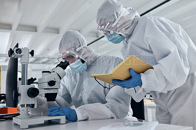 Buy stock photo Scientist team, covid research and microscope with team writing notes or results during analysis of a sample in a science and medical lab. Medical researcher in safety suit in biotechnology laboratory