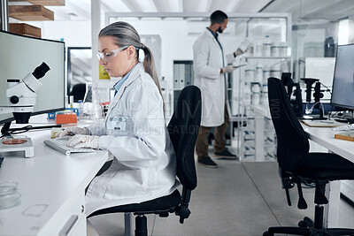 Buy stock photo Laboratory woman, microscope or computer typing in cancer research, medical healthcare innovation or insurance medicine. Mature DNA scientist or science ideas with man in teamwork collaboration study