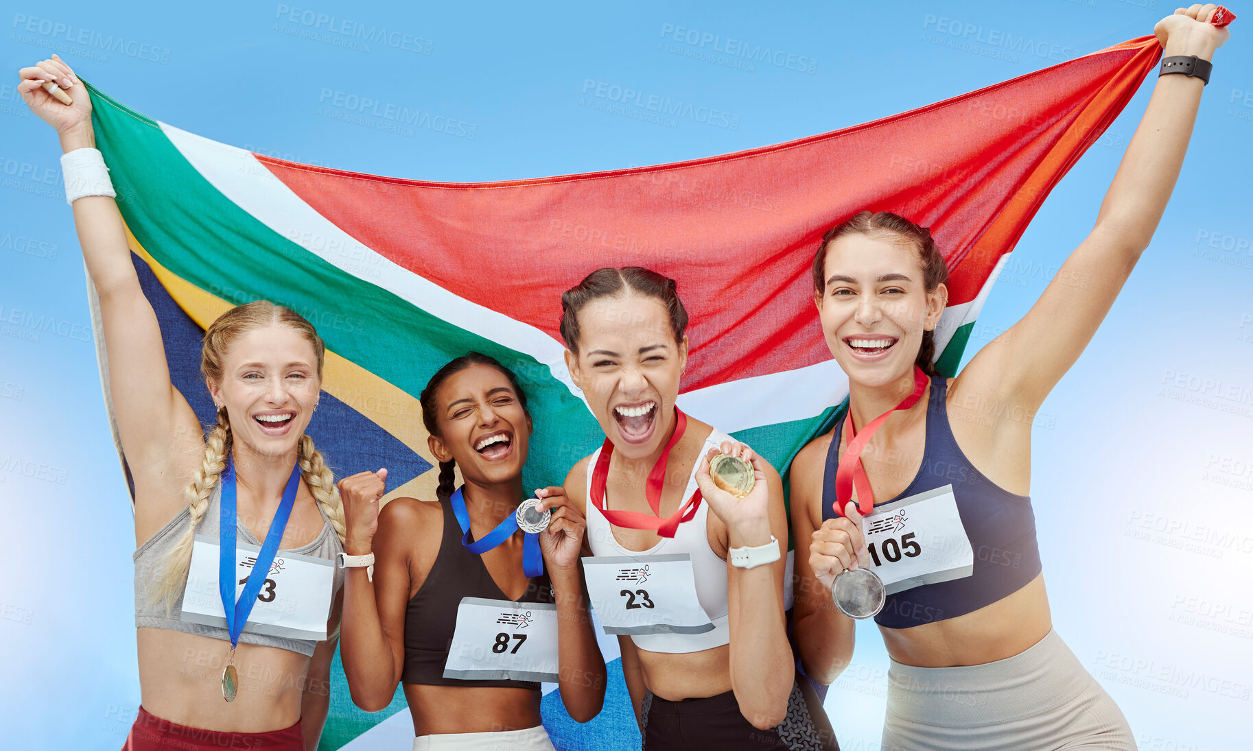 Buy stock photo Portrait diverse group of female olympic athletes holding winners' medals and African flag. Happy and proud champions of South Africa. Winning a medal for your country is an amazing achievement