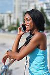 African american woman using smartphone talking on mobile phone call conversation by the beach