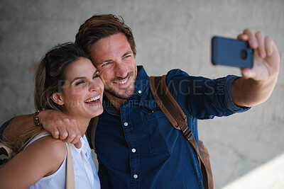 Buy stock photo Happy couple taking photos using smartphone camera sharing vacation together on mobile phone social media having fun summertime