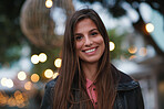 Portrait beautiful woman smiling happy in city evening with lights in background