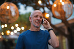 Mature man using smartphone having phone call talking on mobile phone city evening