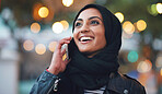 Portrait muslim woman using smartphone having phone call talking on mobile phone in city evening wearing hijab headscarf