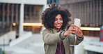 African american woman taking selfie photo using smartphone in city with mobile phone camera