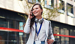 Happy business woman talking using smartphone having phone call conversation in city