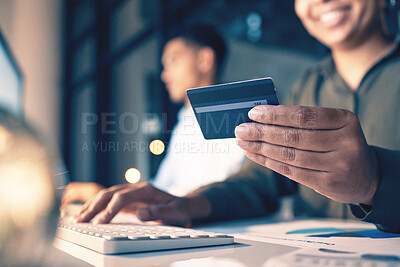 Hands, computer and credit card for ecommerce, online shopping or banking at night on office desk. Hand of employee shopper typing on keyboard for internet purchase, bank app or transaction on table