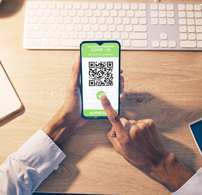 Hands, phone and QR code of covid vaccination for online passport, travel or business trip at night by office desk. Hand of employee holding smartphone with approved verification for traveling