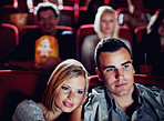 Love couple at cinema or movie theatre to watch entertainment film together at movie theater on a romantic date. Young happy people smile, romance and relationship at movies cinematography theater